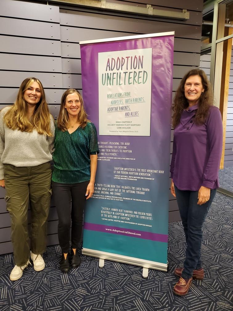 Kelsey, Sara, Lori, and the Adoption Unfiltered banner on the first book tour